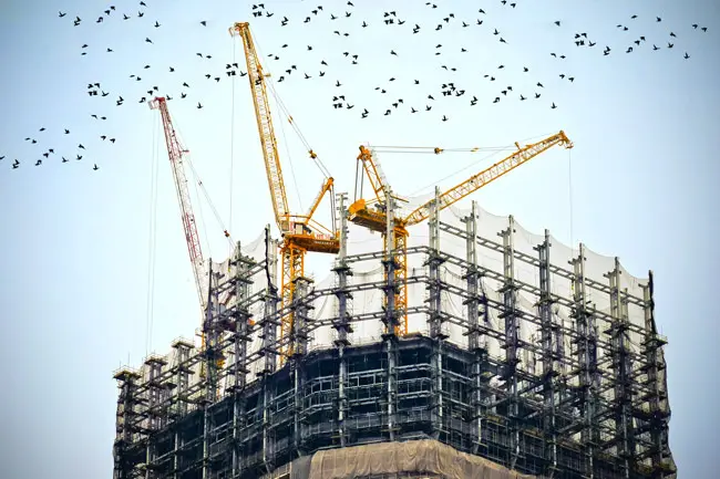 Tower cranes over a high-rise under construction